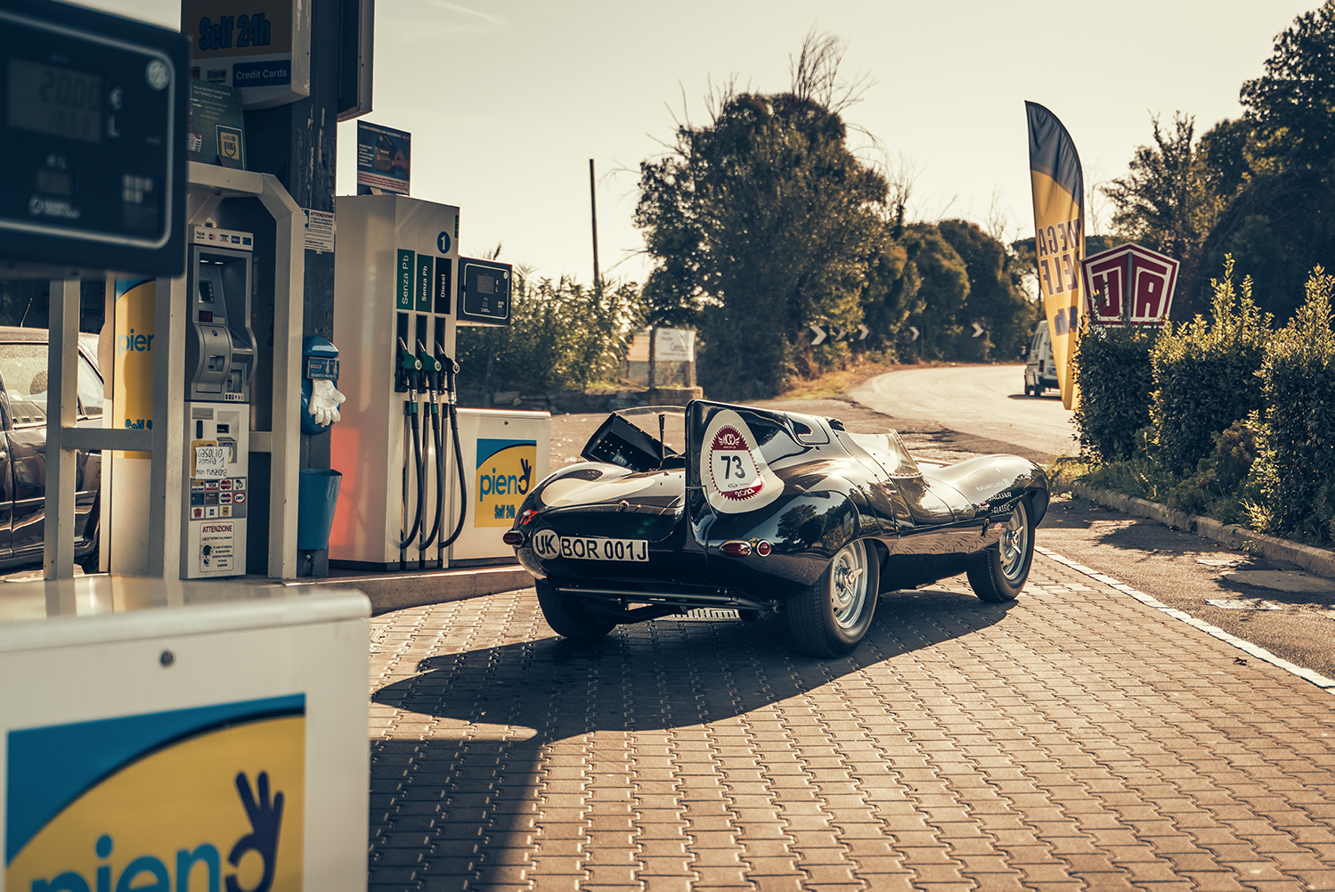 Filling up a Jaguar D-type Continuation at a gas station