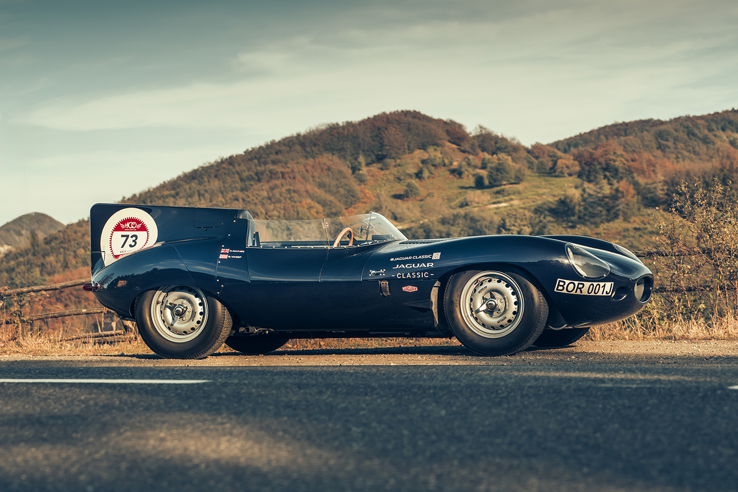 A Jaguar Classic D-type Continuation sitting on a road in rural Italy