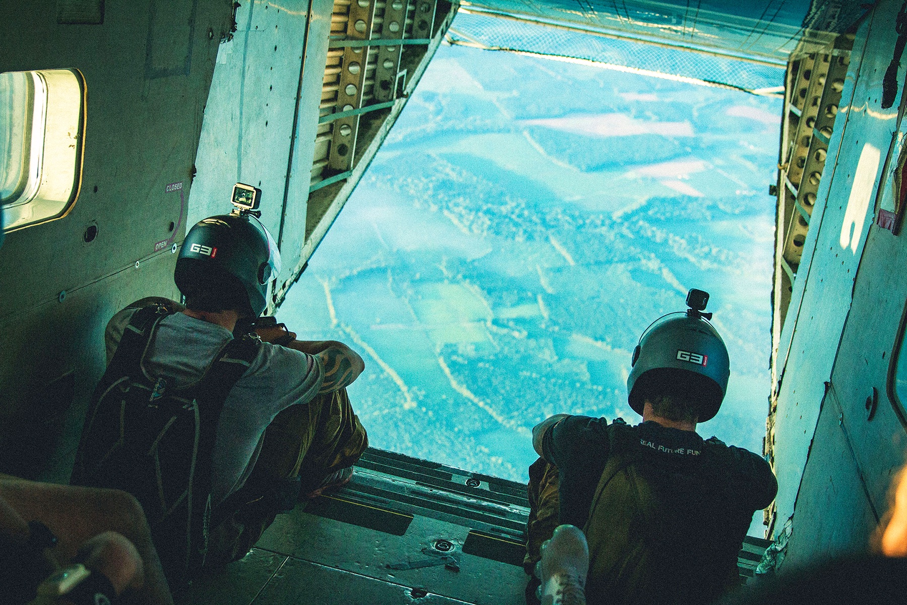 A pair of men sitting at the back of an airplane before skydiving, the start of the Navy SEAL-inspired Monster Mash marathon.