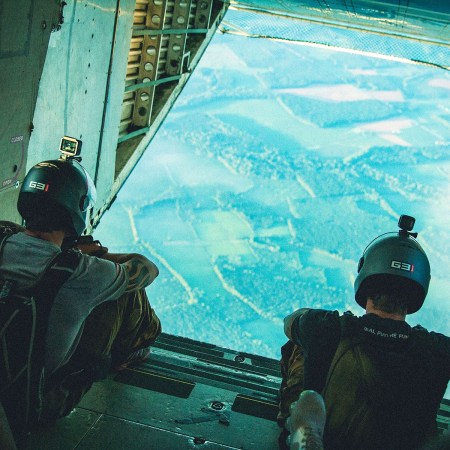 A pair of men sitting at the back of an airplane before skydiving, the start of the Navy SEAL-inspired Monster Mash marathon.