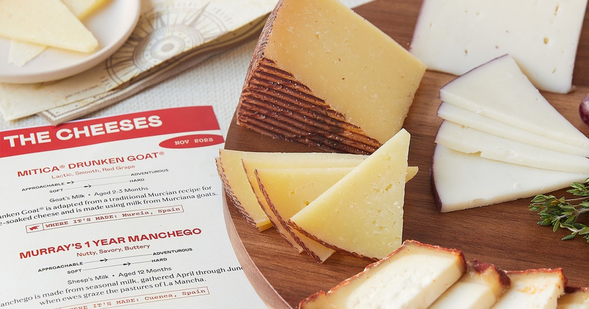A platter of different cheeses sitting next to a piece of paper describing them