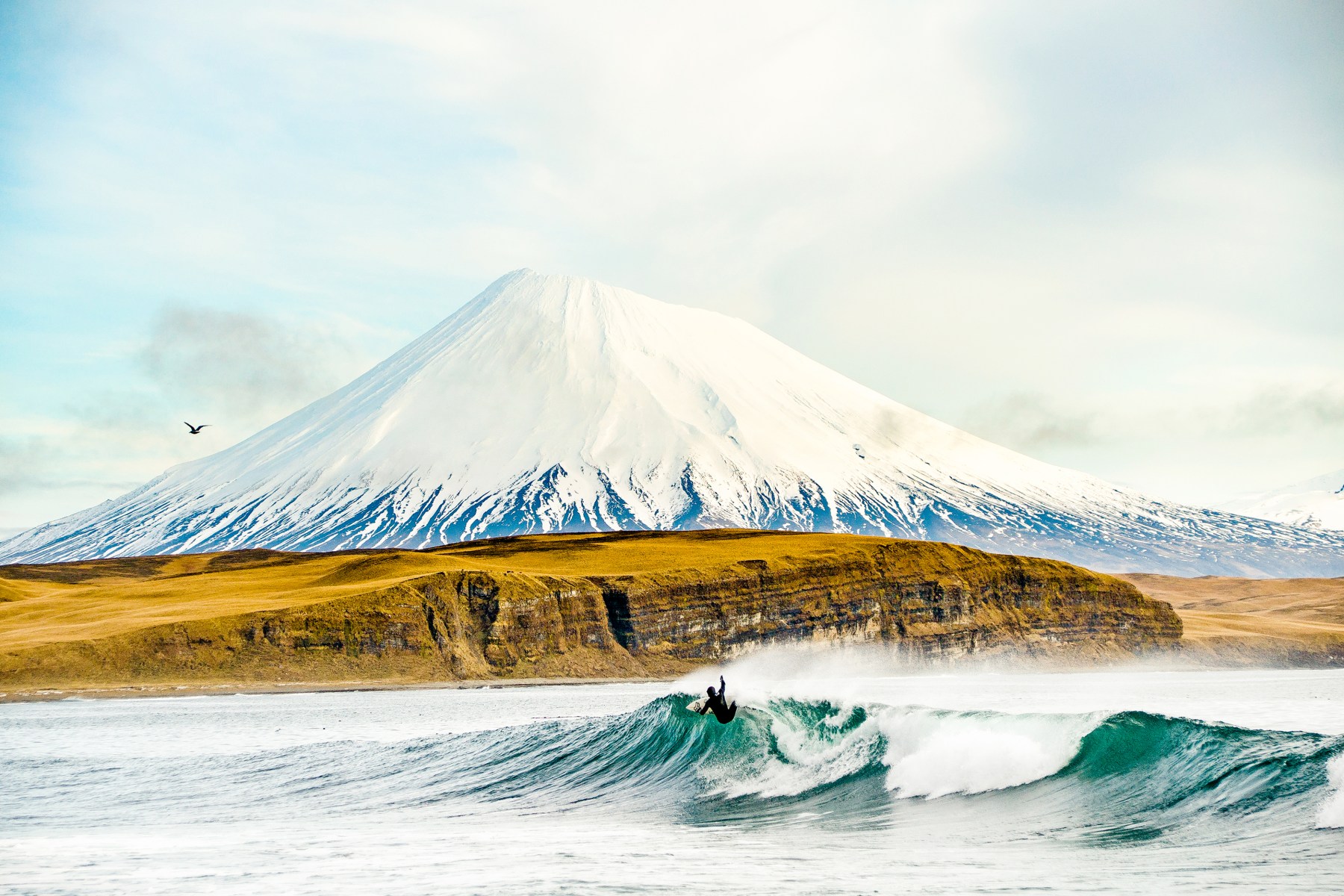 This is Josh Mulcoy in the Aleutian Islands, this remote island chain that basically extends from Russia to Alaska. It’s a wild place and a place I'd always dreamt of going to for years. I finally went a few years ago and shot an article for <em>SURFER Magazine</em>. This photo is critical to me in my career because it speaks volumes about how hard you work to get to these places. Oftentimes you go and the weather sucks or the waves aren't good and it just doesn't work out how you planned. In this situation, it did and everything came to life. Surfing and finding good waves in remote areas is still very much at the core of what I love and this photograph in that place with the clearing sky was a big moment in my career. We saw the volcano maybe one more day, but that was the clearest, best day of photographing we had. It’s a moment that sits with me in my memory bank and in the archive.