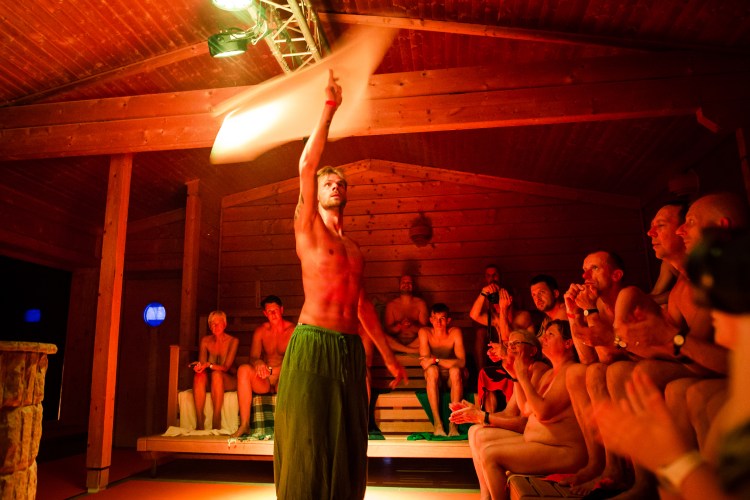 A "saunameister" performing aufguss in a sauna.