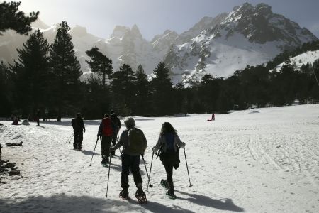 A group snowshoeing on a mountain in France.