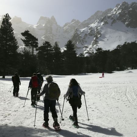 A group snowshoeing on a mountain in France.