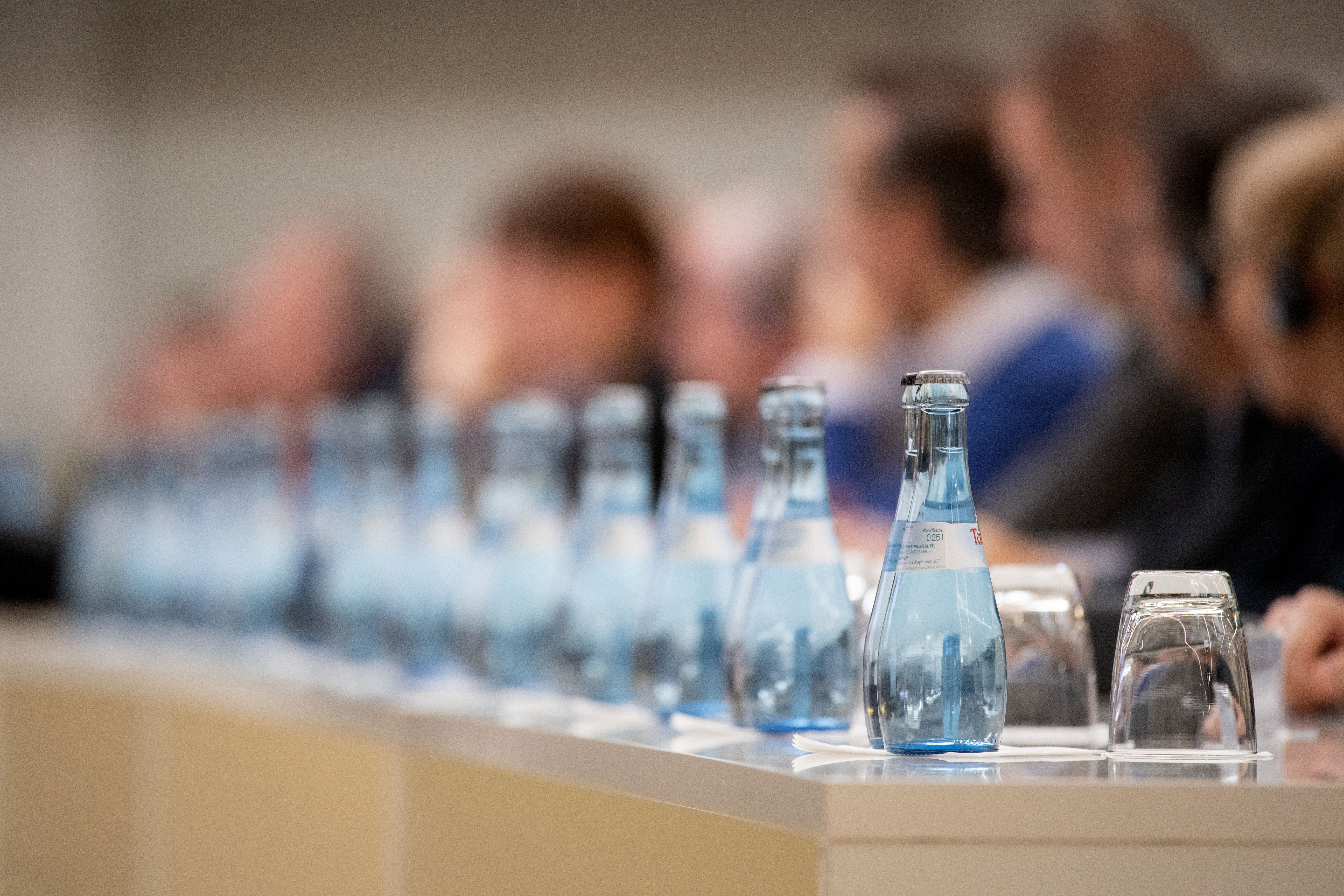 A row of glass water bottles.