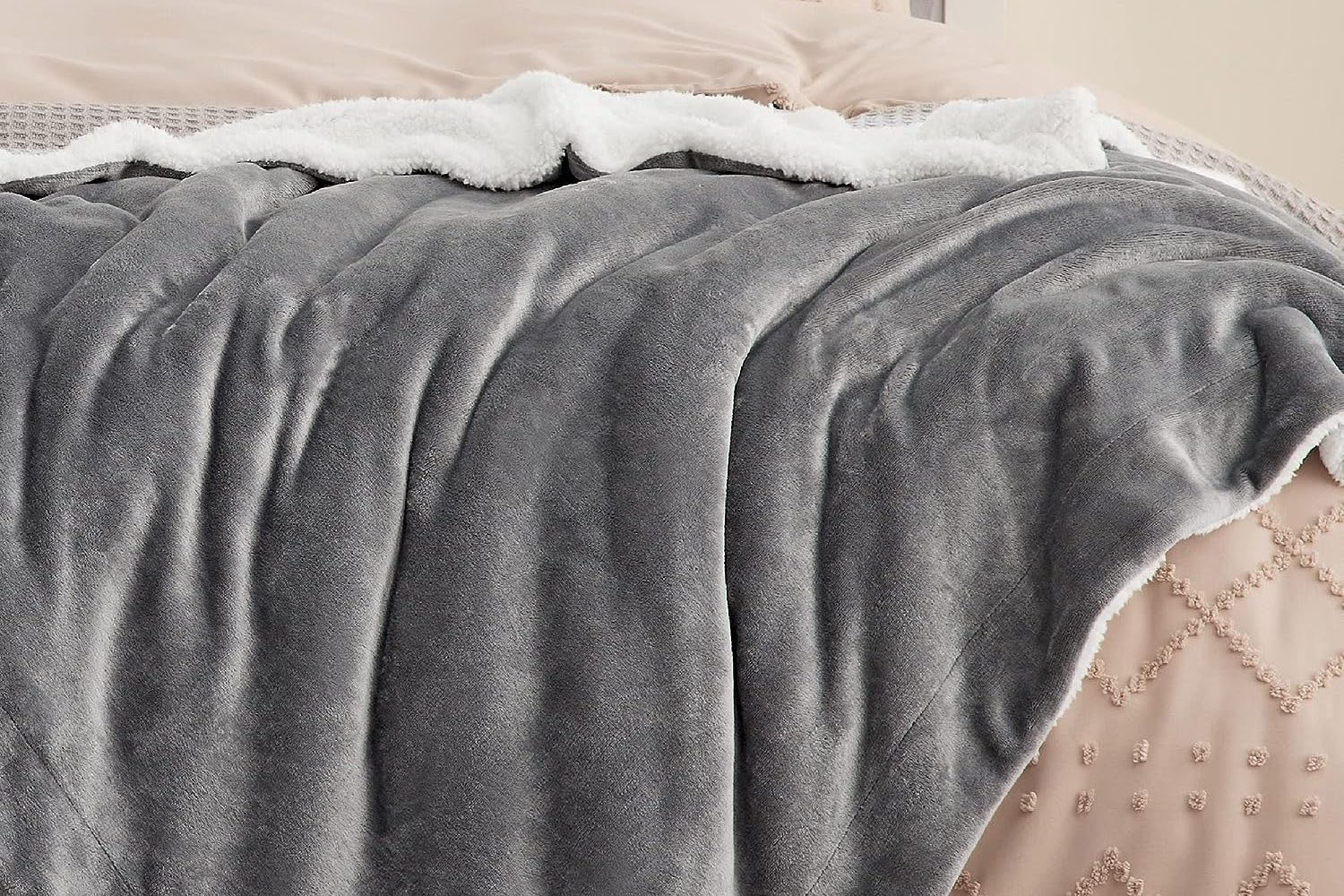 a grey Bedsure Fleece Blanket on a bed