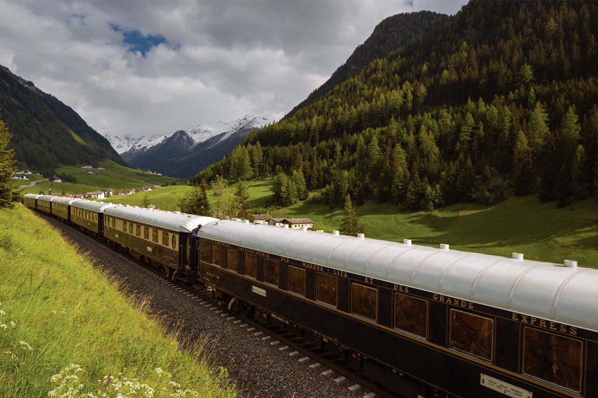 The Venice Simplon-Orient-Express, a Belmond Train, moving through the countryside