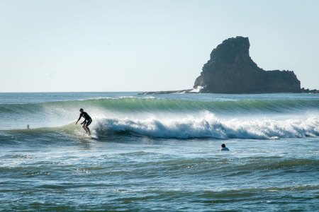 A surfer riding the waves on the Pacific Ocean. We get some advice on booking your first surf vacation from a founder of Kalon Surf in Costa Rica.