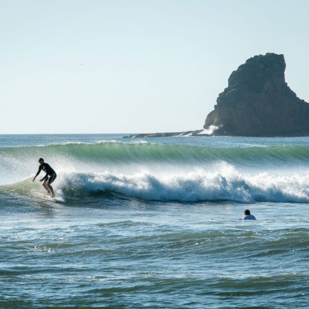 A surfer riding the waves on the Pacific Ocean. We get some advice on booking your first surf vacation from a founder of Kalon Surf in Costa Rica.