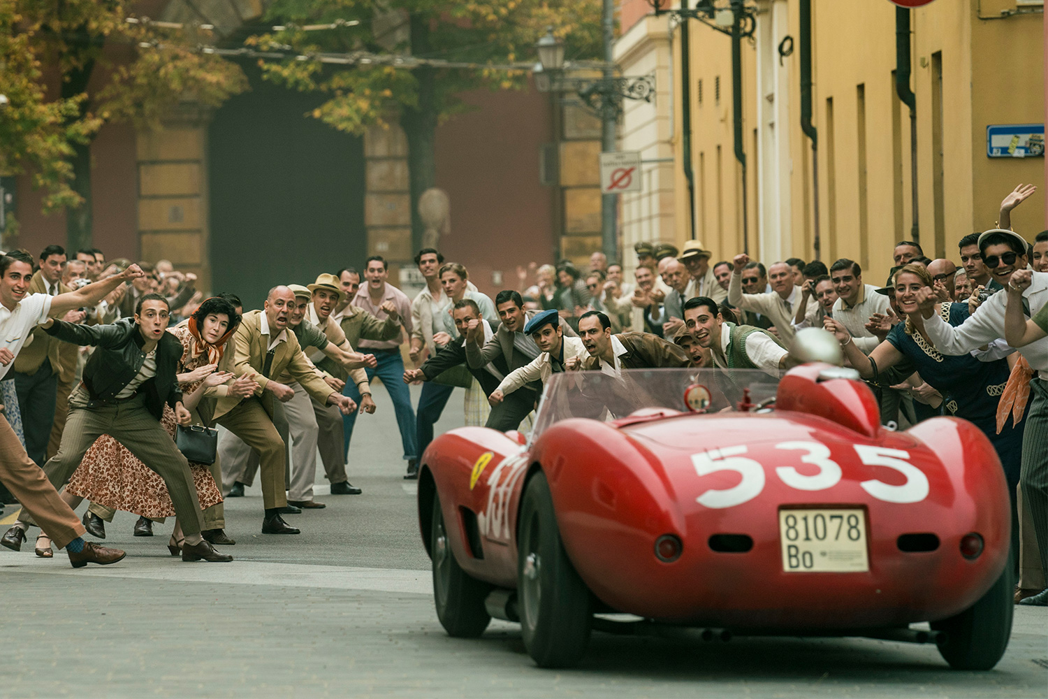 A Ferrari driving down the street in Michael Mann's movie "Ferrari"