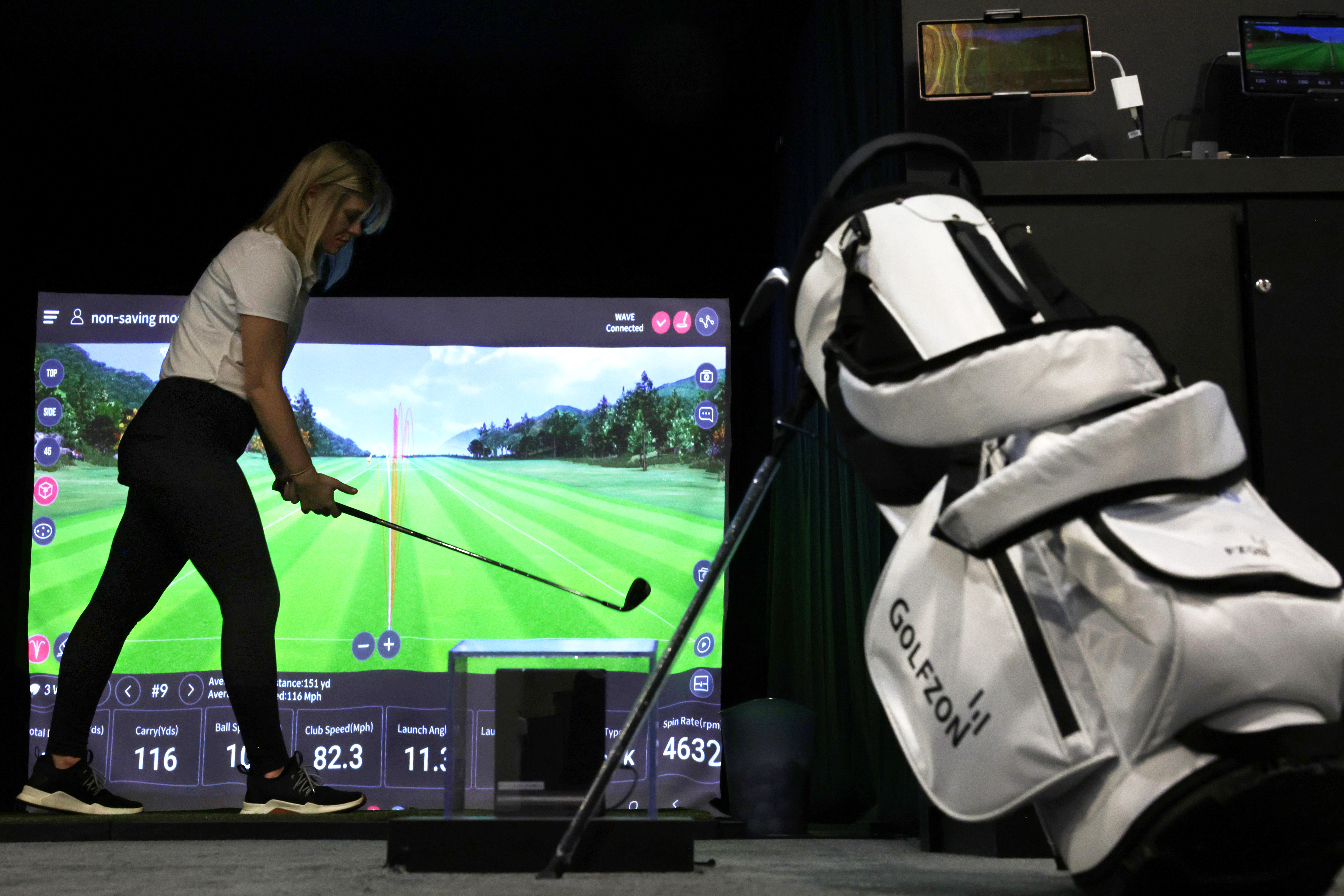 A Golfzon employee demonstrating the sim's new technology.