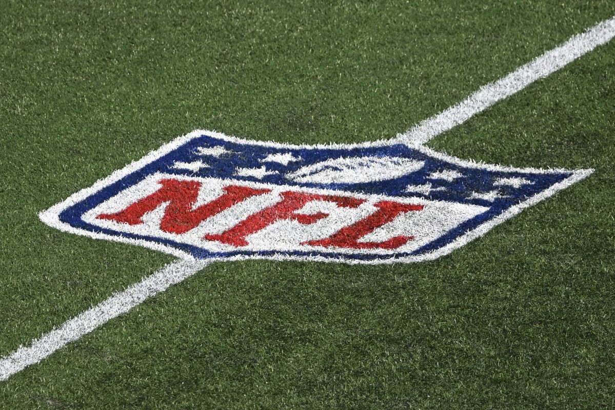 The National Football League logo on the field.