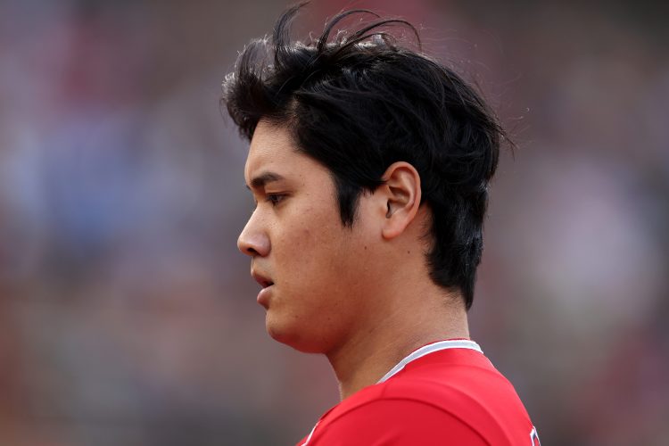 Shohei Ohtani walks back to the dugout.