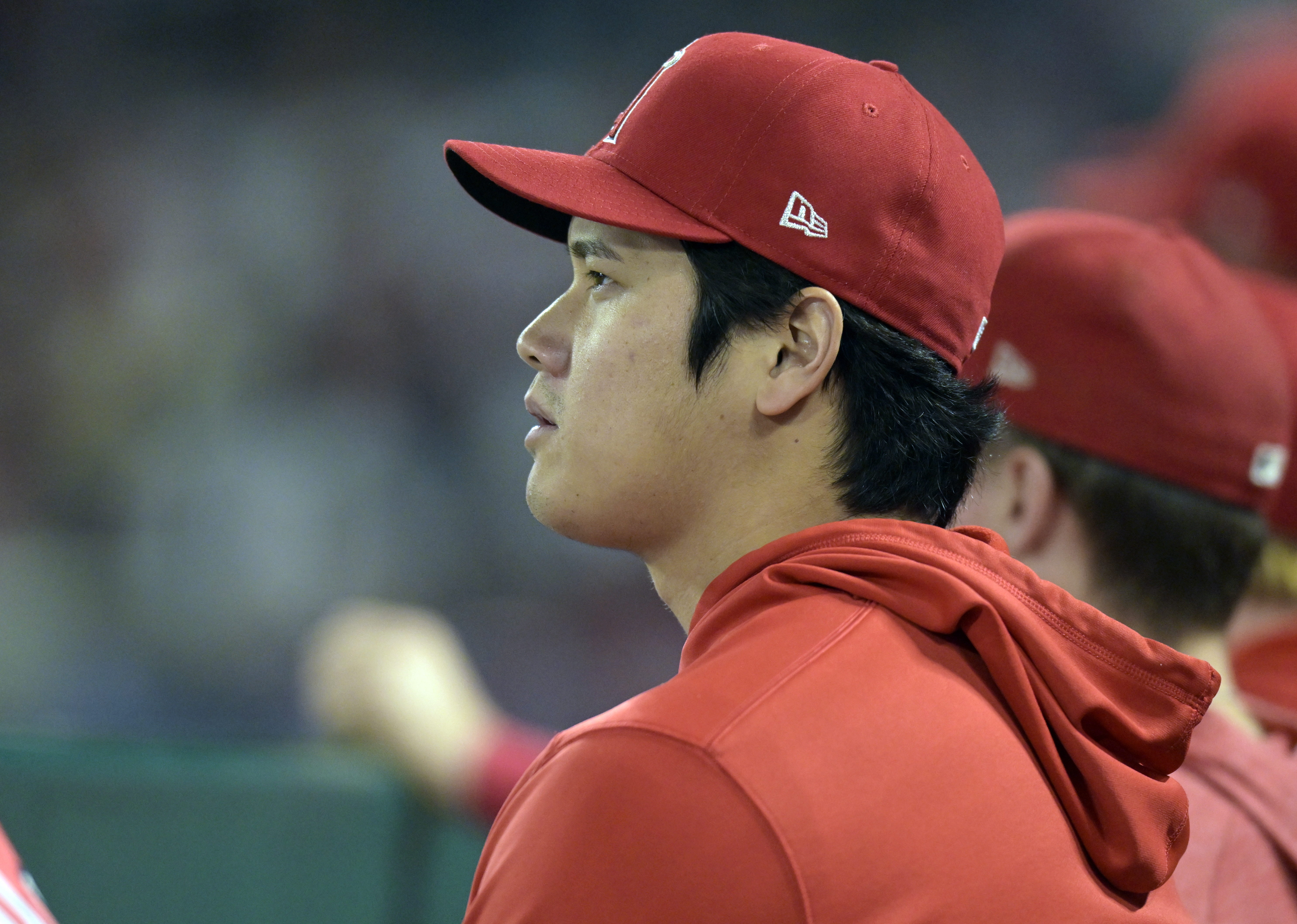 Shohei Ohtani sits on the bench at Angel Stadium.