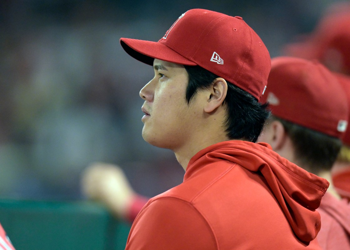 Shohei Ohtani sits on the bench at Angel Stadium.