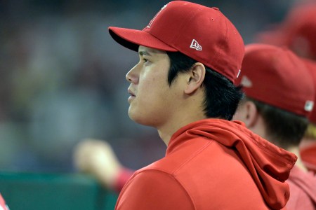 Shohei Ohtani sits on the bench at Angel Stadium.