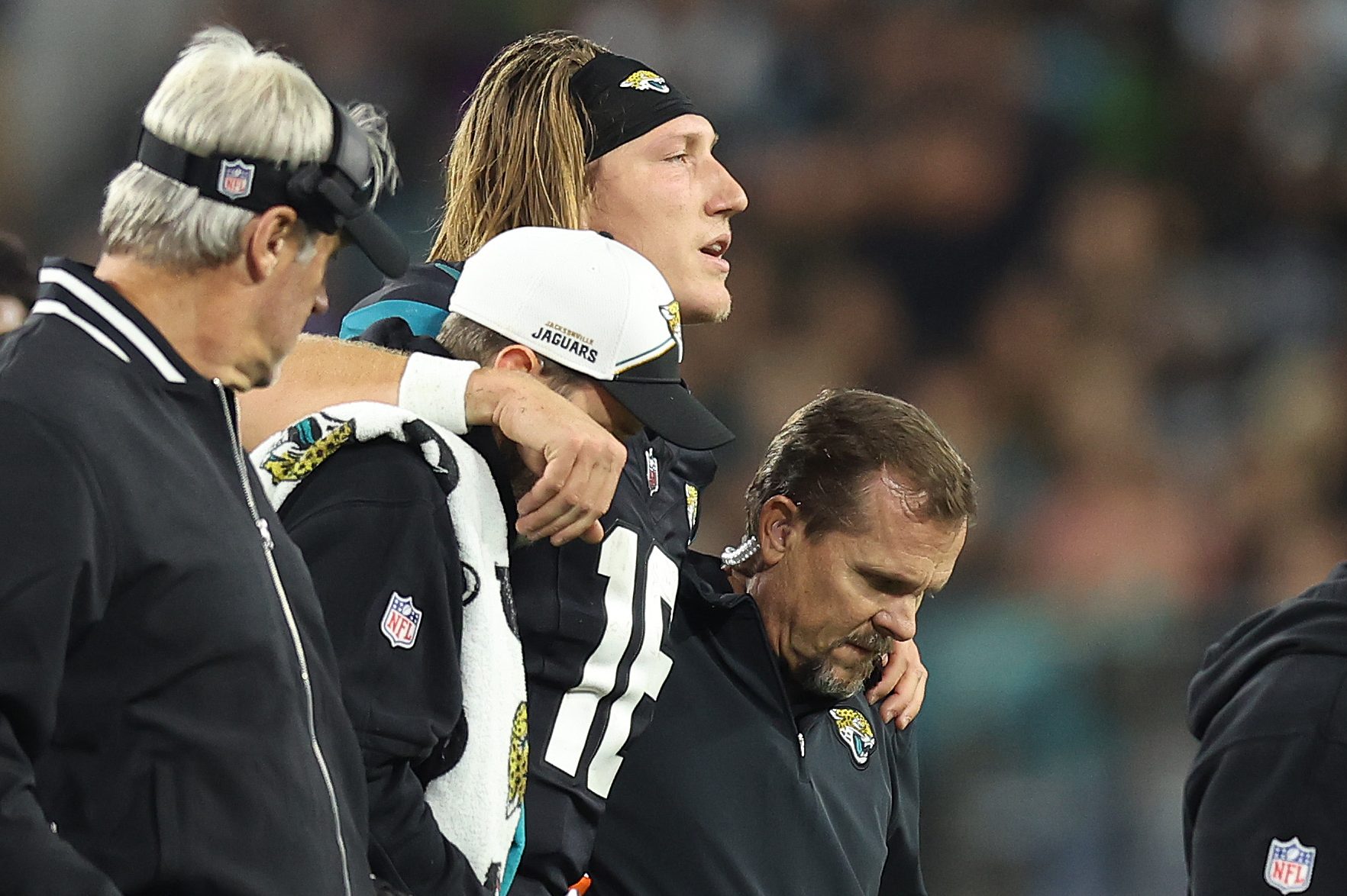 Trevor Lawrence of the Jaguars is helped after being injured.