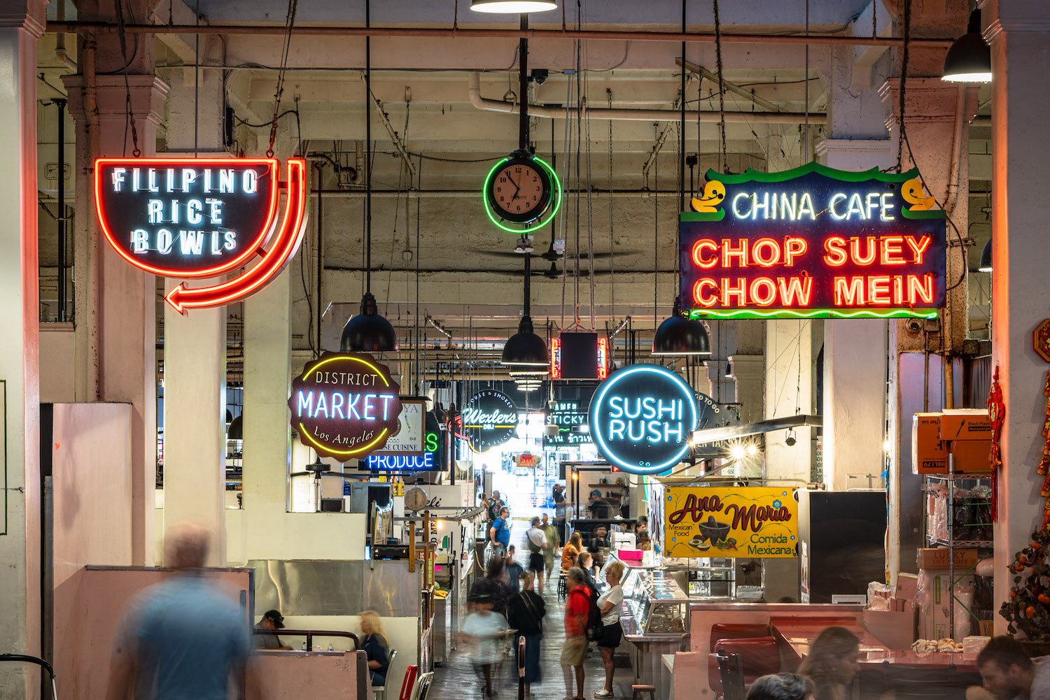 Neon signs hanging from inside of the Grand Central Market