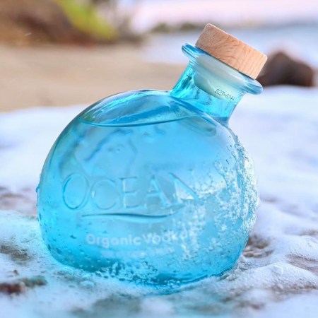 Ocean Organic Vodka bottle on a beach