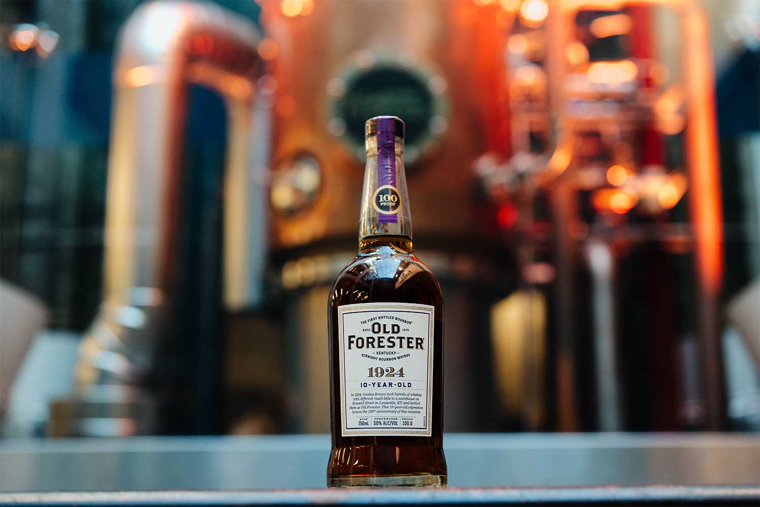 A bottle of the new Old Forester 1924 in front of a still