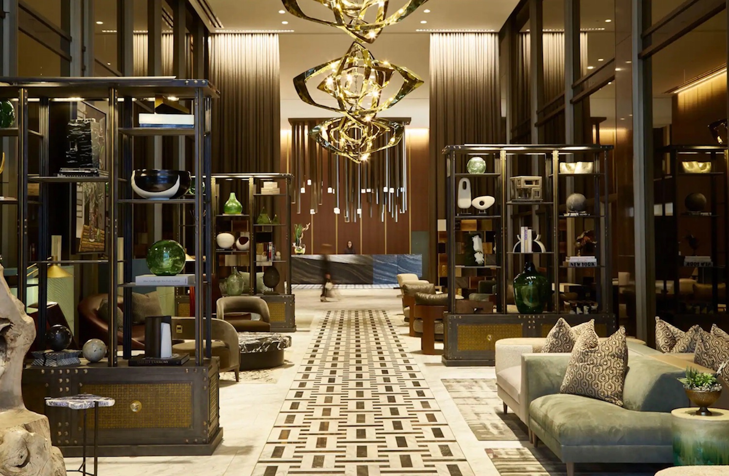 Walkway in Thompson Dallas hotel with gold and brown accents that give a luxury feeling to the space
