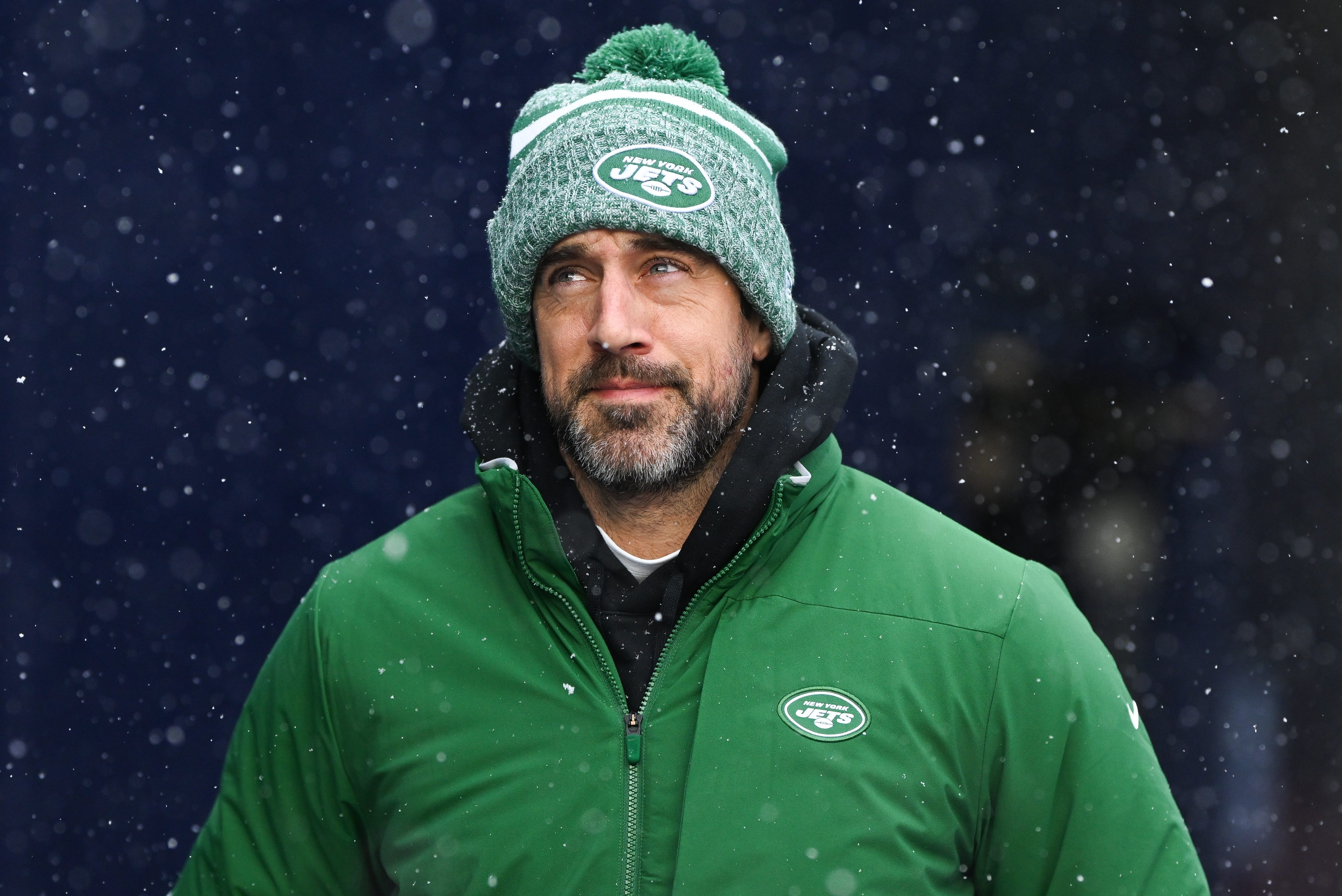 Aaron Rodgers of the Jets runs onto the field.