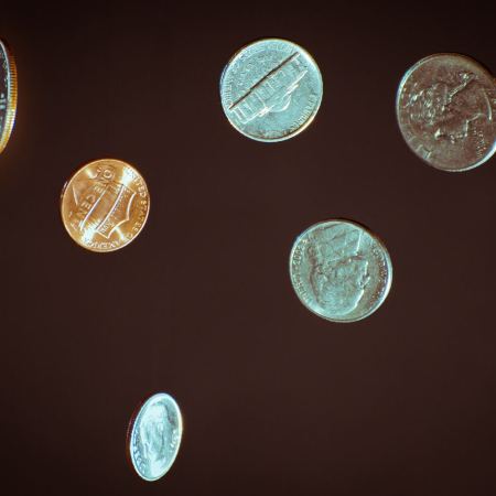 Various U.S. coins in the air on a dark background. New research suggests flipping a coin comes with a slightly favorable bias to one side.