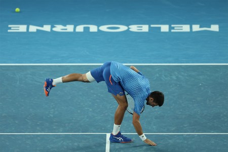 Novak Djokovic leaning over to touch the court in appreciation at the Australian Open. Here's our full guide to the 2024 Australian Open.