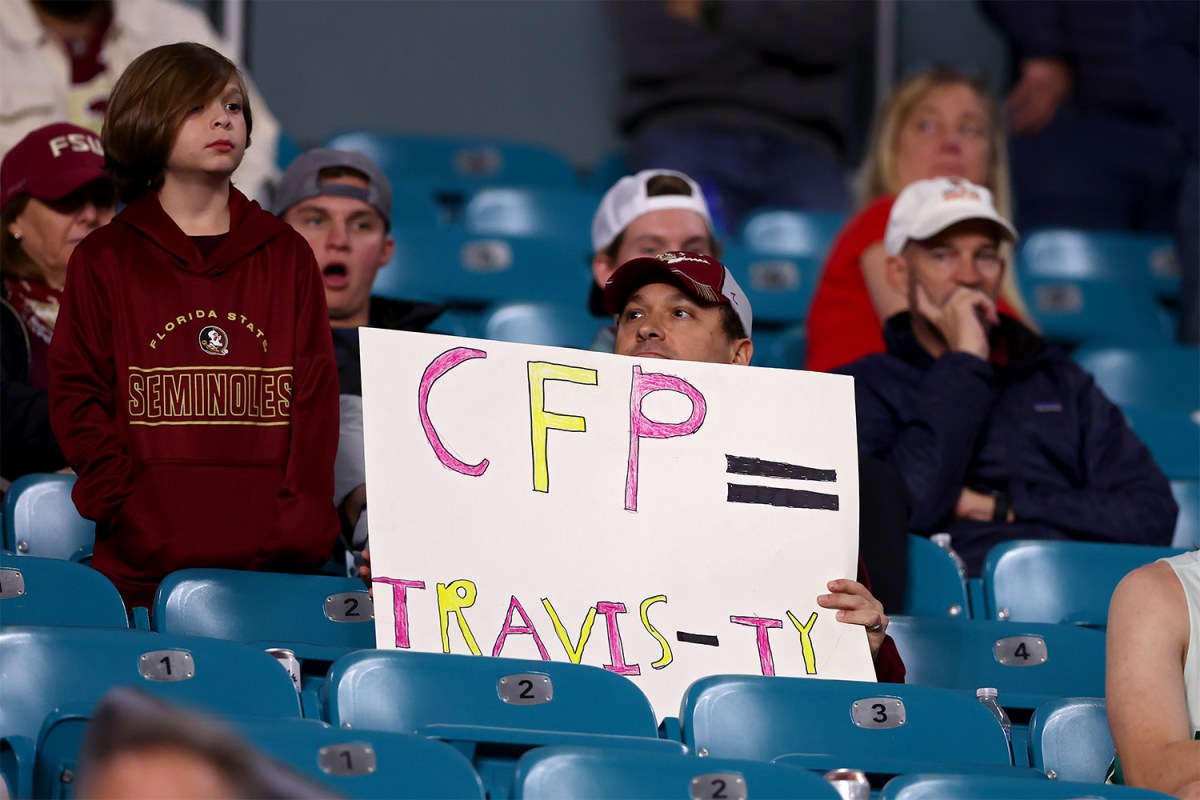 A fan holds a sign against the CFP during the Capital One Orange Bowl between the Georgia Bulldogs and the Florida State Seminoles