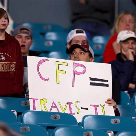 A fan holds a sign against the CFP during the Capital One Orange Bowl between the Georgia Bulldogs and the Florida State Seminoles