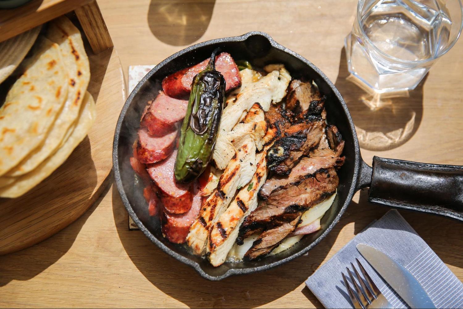 Cast iron skillet with food on a table 