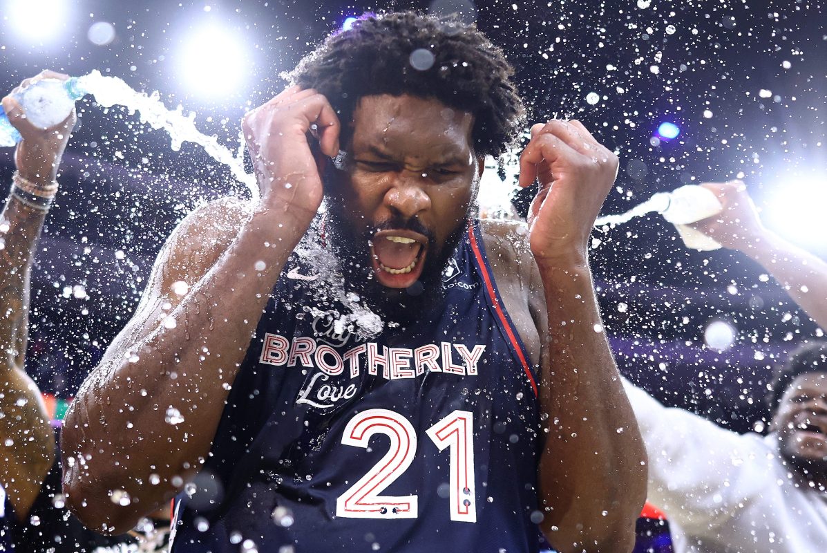 Joel Embiid is showered with water after scoring a team-record 70 points.