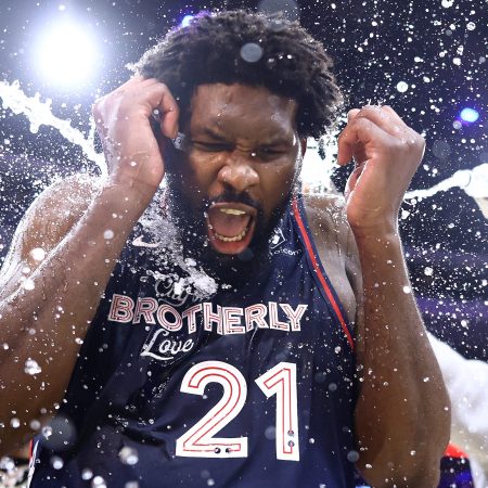 Joel Embiid is showered with water after scoring a team-record 70 points.