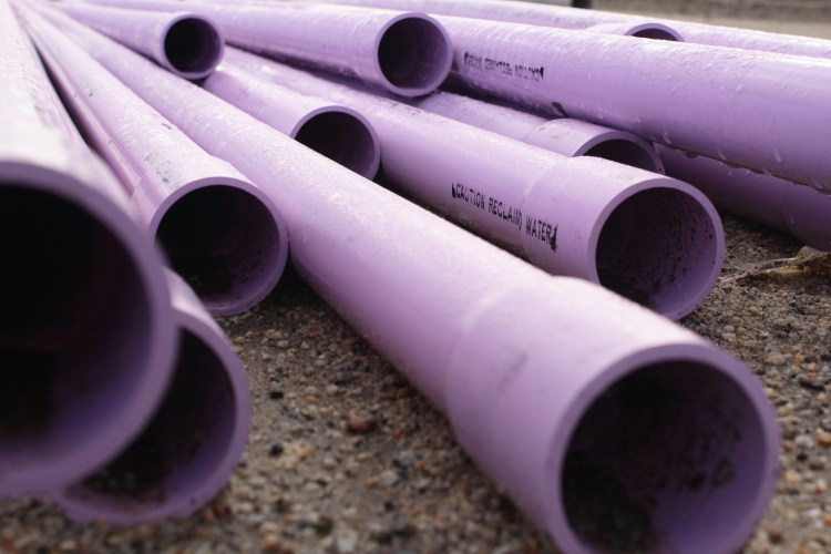 A close-up of purple PVC pipes.