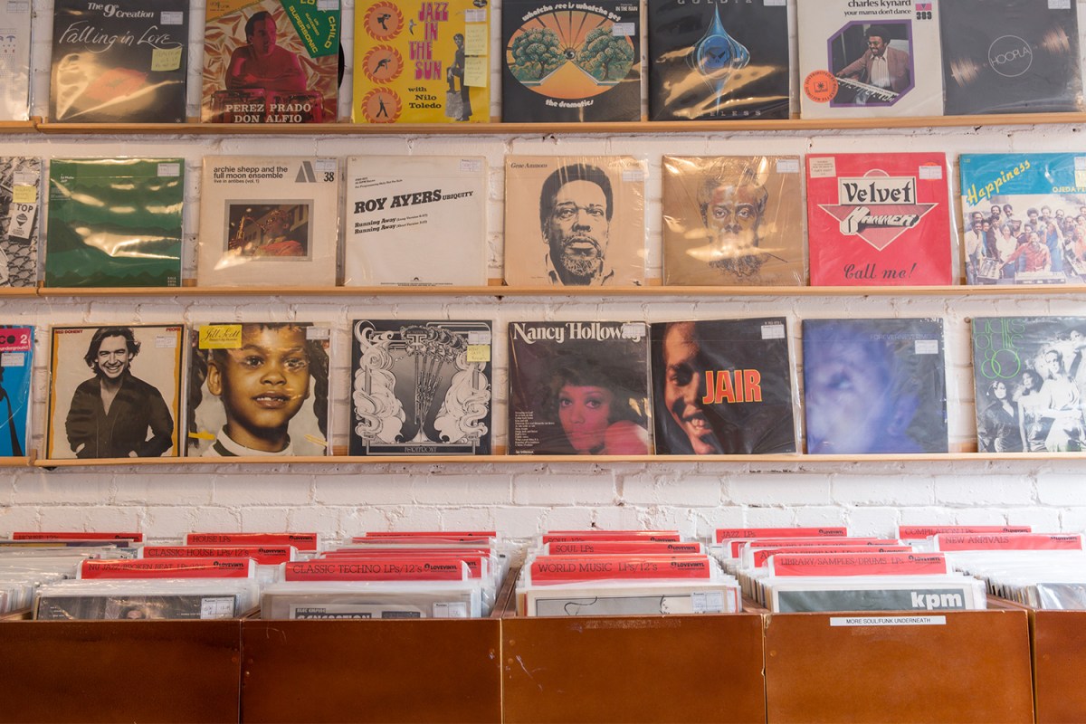 A wall of classic rock records. Here are some mental-health benefits you can reap from listening to new music.