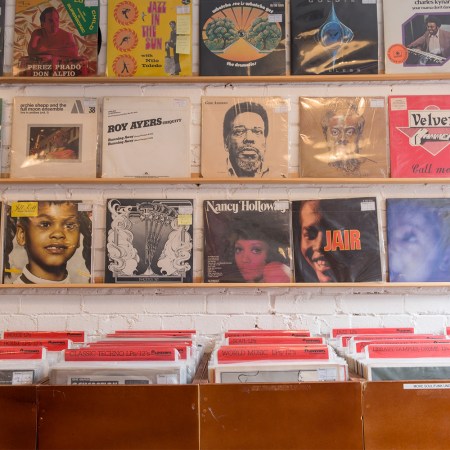 A wall of classic rock records. Here are some mental-health benefits you can reap from listening to new music.