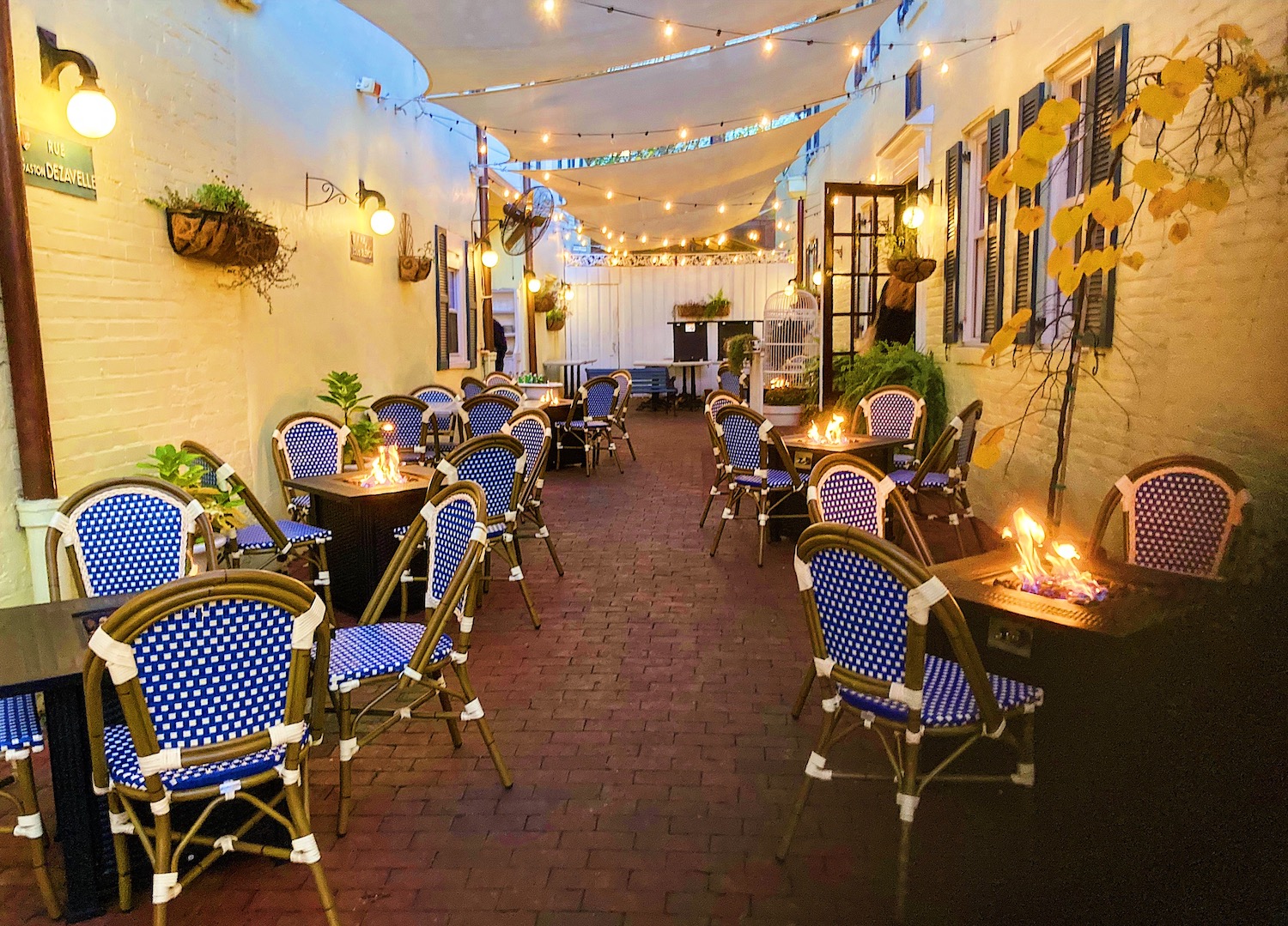 Patio area with blue chairs and string lights