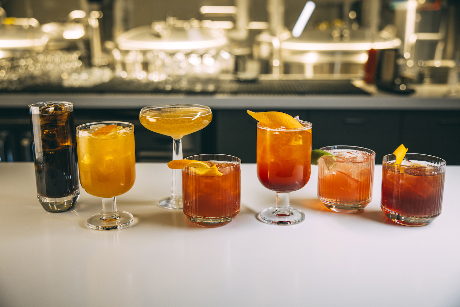 Cocktails in a row on a countertop