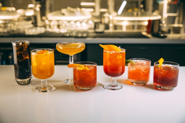 Cocktails in a row on a countertop