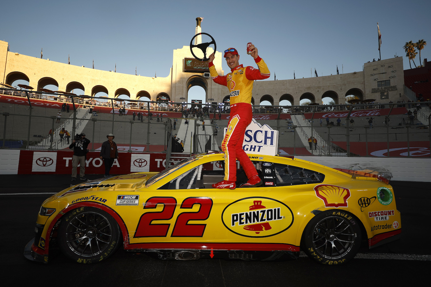 Joey Logano, driver of the #22 Shell Pennzoil Ford, celebrates in victory lane after winning the NASCAR Cup Series Busch Light Clash at the Los Angeles Memorial Coliseum on February 06, 2022 in Los Angeles, California. 