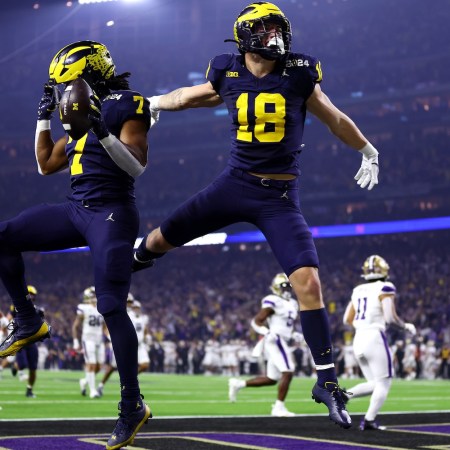 Donovan Edwards #7 of the Michigan Wolverines celebrates with Colston Loveland #18 after running the ball for a touchdown in the first quarter against the Washington Huskies during the 2024 CFP National Championship game at NRG Stadium on January 08, 2024 in Houston, Texas.