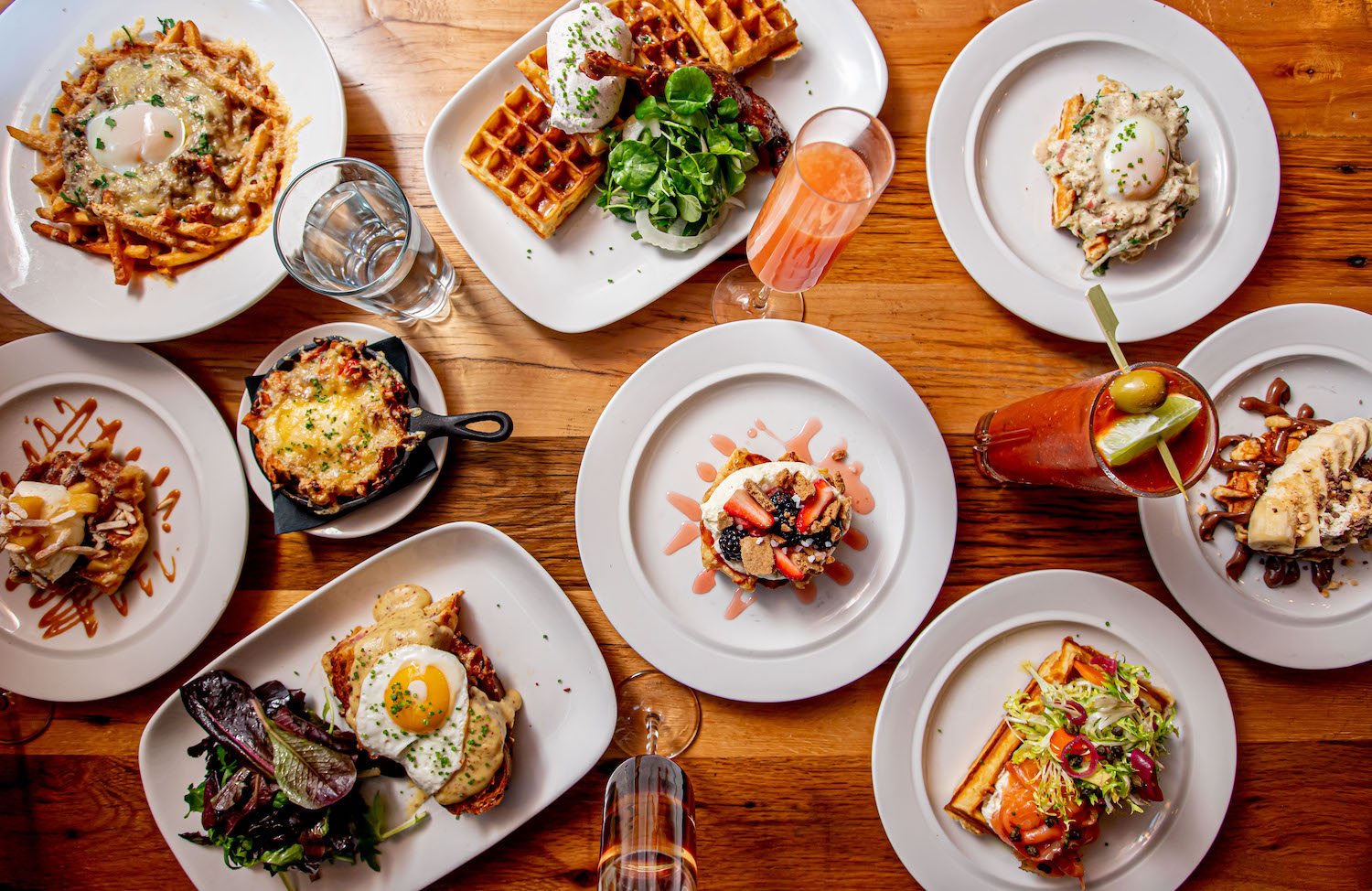 Birds-eye view of a table filled with various brunch plates 