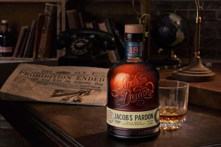Jacob's Pardon Small Batch No. 3 "light whiskey" on a table with a newspaper announcing Prohibition ended.