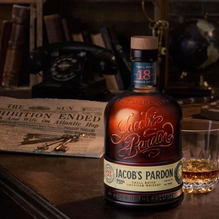 Jacob's Pardon Small Batch No. 3 "light whiskey" on a table with a newspaper announcing Prohibition ended.