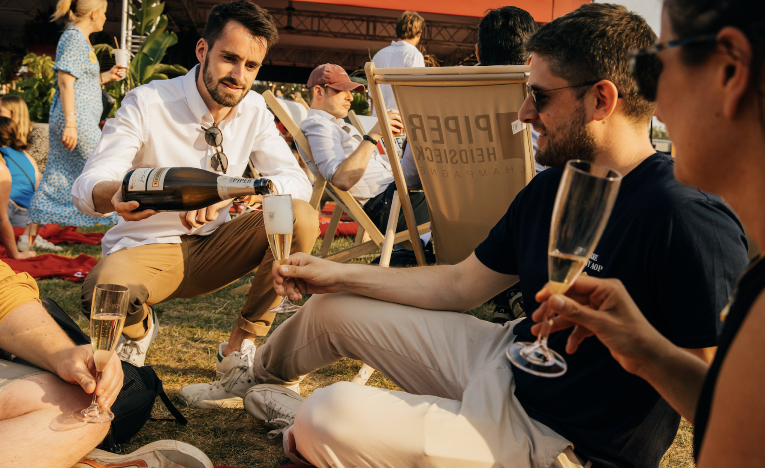 man pouring champagne into another man's glass