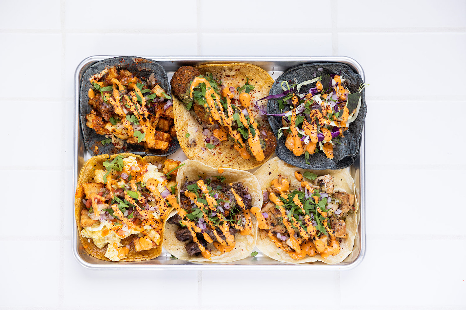 Spread of tacos on a tray
