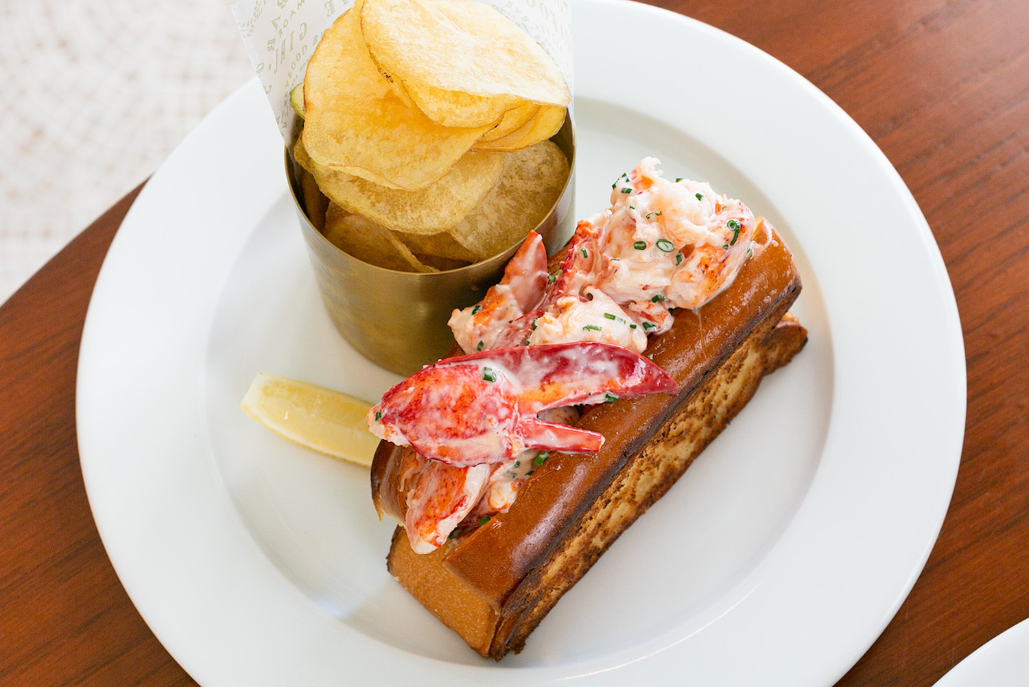 Lobster roll with a side of potato chips