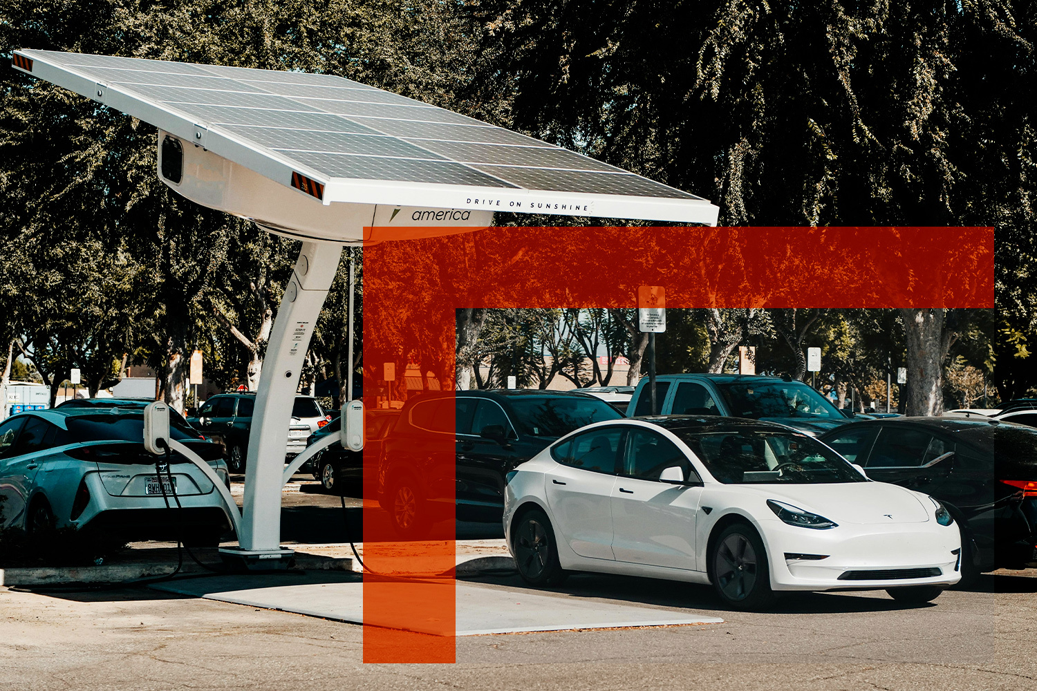 A Tesla EV charging at a solar-powered charging station