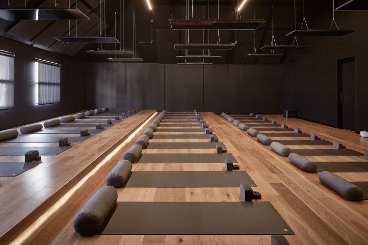 A hot yoga studio with empty mats. We look at what the science says about hot yoga's benefits, especially when it comes to depression.